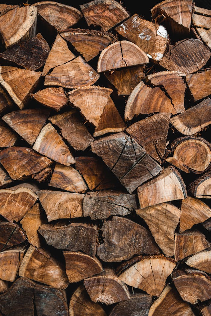 Vertical shot of stacked wood logs, perfect for rustic backgrounds or wallpaper.