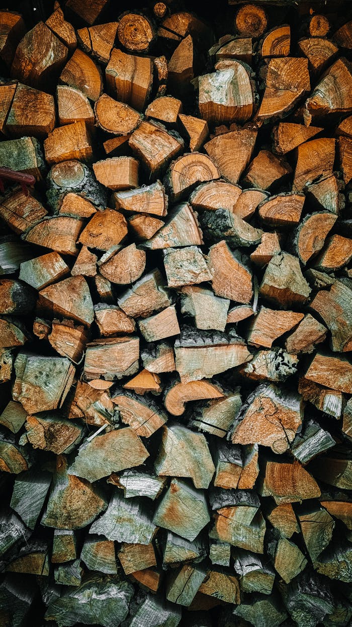 A close-up view of neatly stacked firewood pieces, ideal for rustic and natural-themed designs.